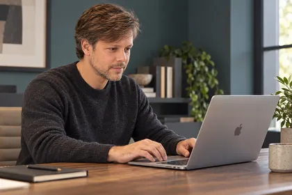 Illustrative scene: your marketing professional working at his Mac, directing and reviewing the work.
